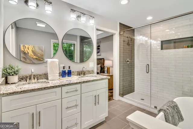 a bathroom with double vanity sink and a mirror