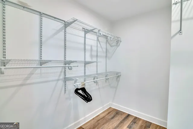 a view of walk in closet with empty racks