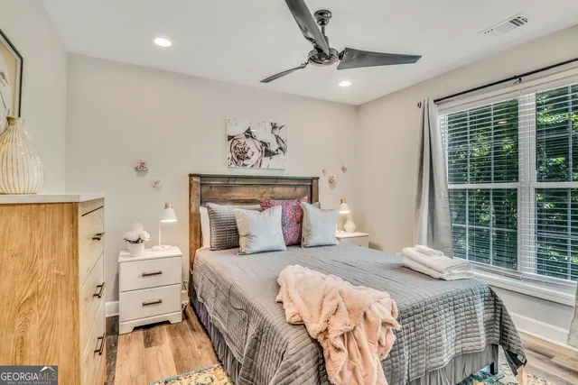 a bedroom with a large bed and a window