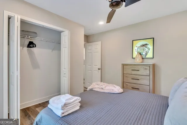 a view of a bedroom with wooden floor