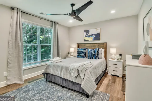 a bedroom with a large bed and a window