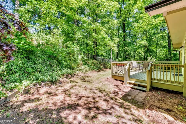 a green field with trees in the background