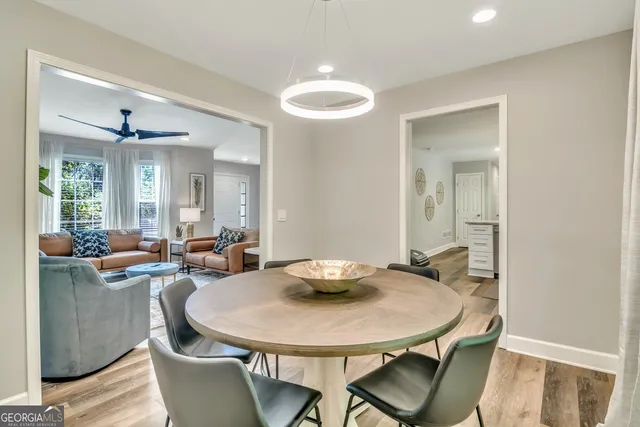 a view of a dining room with furniture and wooden floor