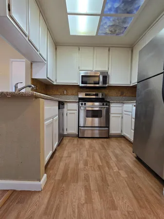 a kitchen with stainless steel appliances a stove and a refrigerator