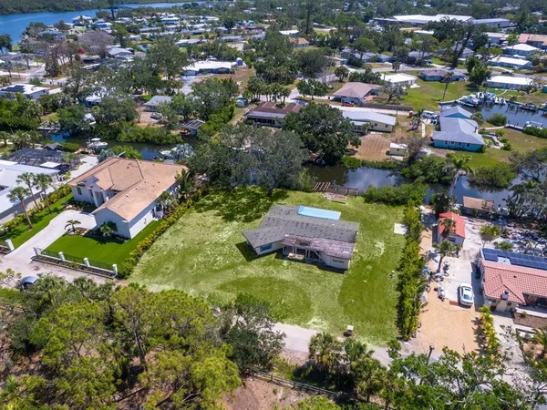 an aerial view of residential houses with outdoor space and lake view