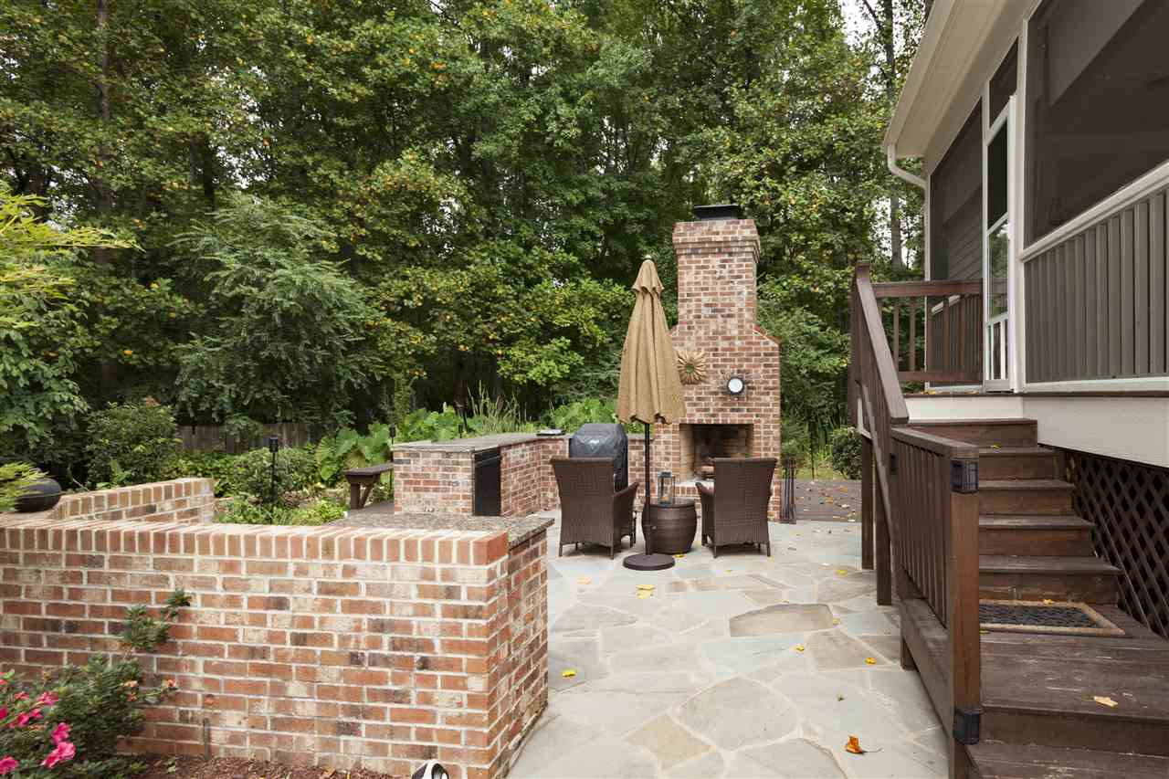1700 Struble Circle Willow Spring, NC 27592 - Photo 22 of 25 Delightful outdoor kitchen area, gas is plumbed for and outdoor stove/grill, enjoy the amazing fire pitt, all brick construction, relax on the wonderful patio next to a fire! Outdoor Kitchen Area