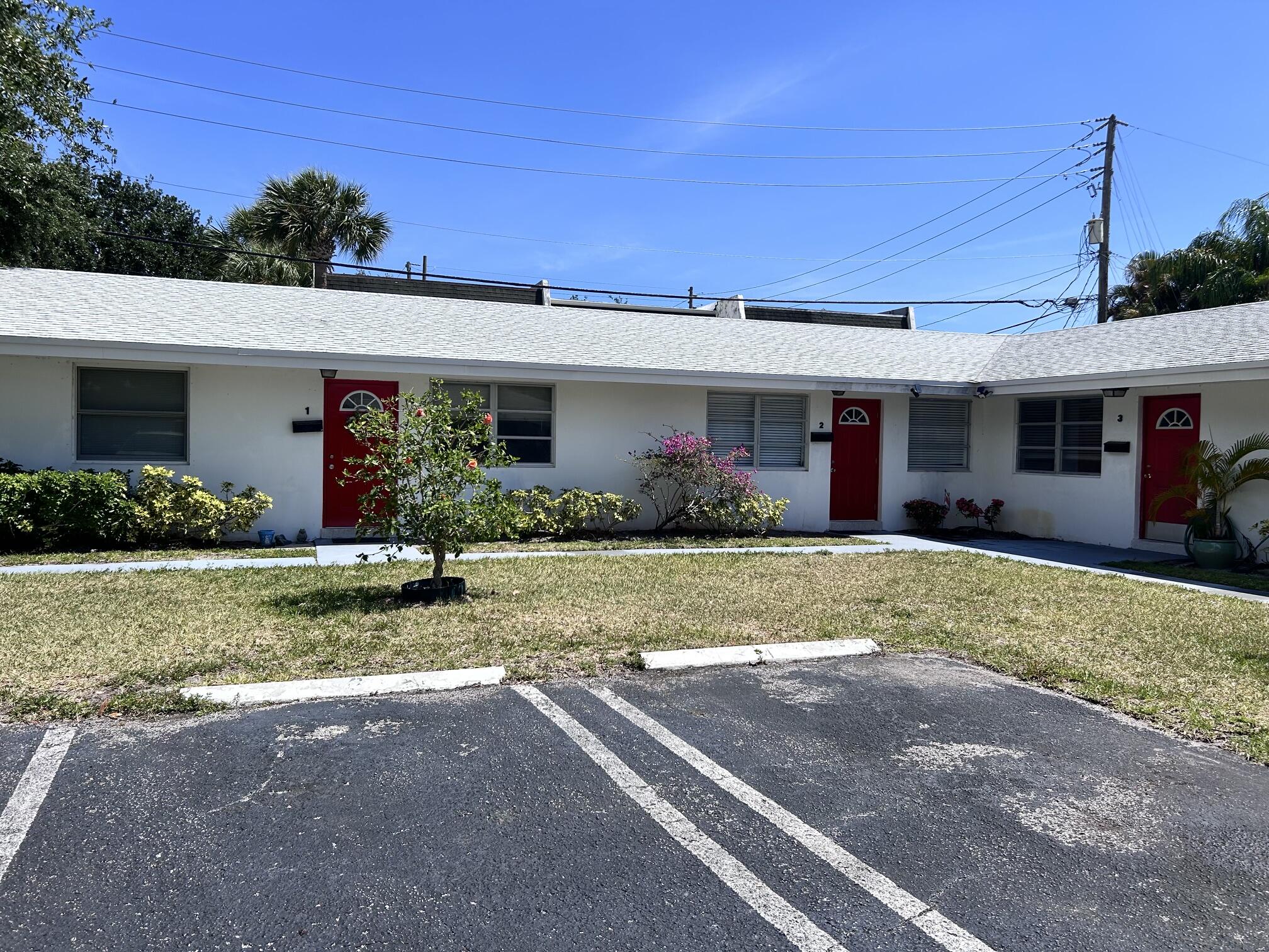 630 Prosperity Farms Road, Unit 2 North Palm Beach, FL 33408 - Photo 3 of 13 a front view of house with yard