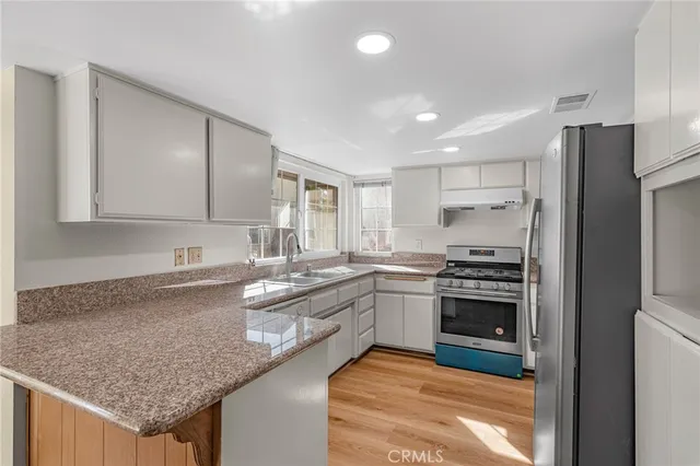 a kitchen with a sink stove and refrigerator
