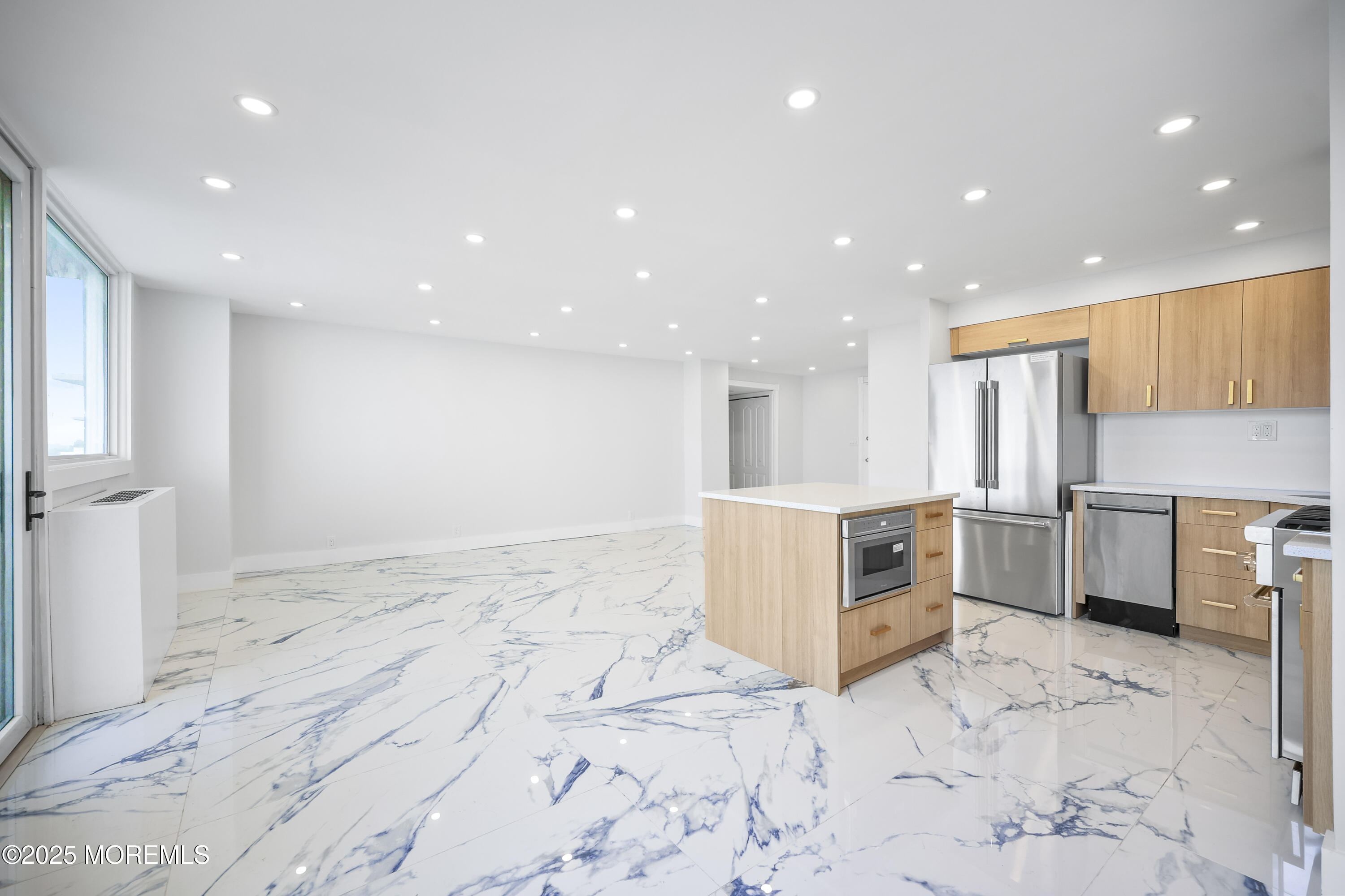 675 Ocean Avenue, Unit 9F Long Branch, NJ 07740 - Photo 11 of 31 a large white kitchen with kitchen island granite countertop a large counter top and appliances