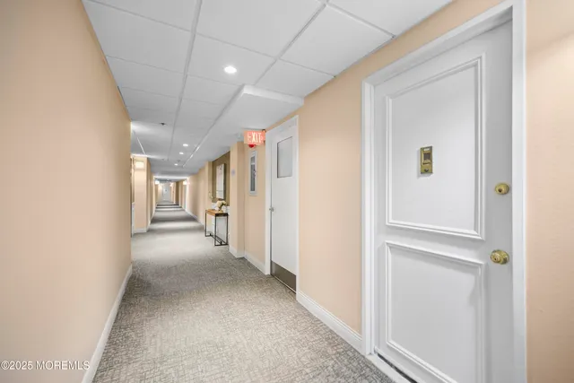 a view of a hallway with wooden shelves
