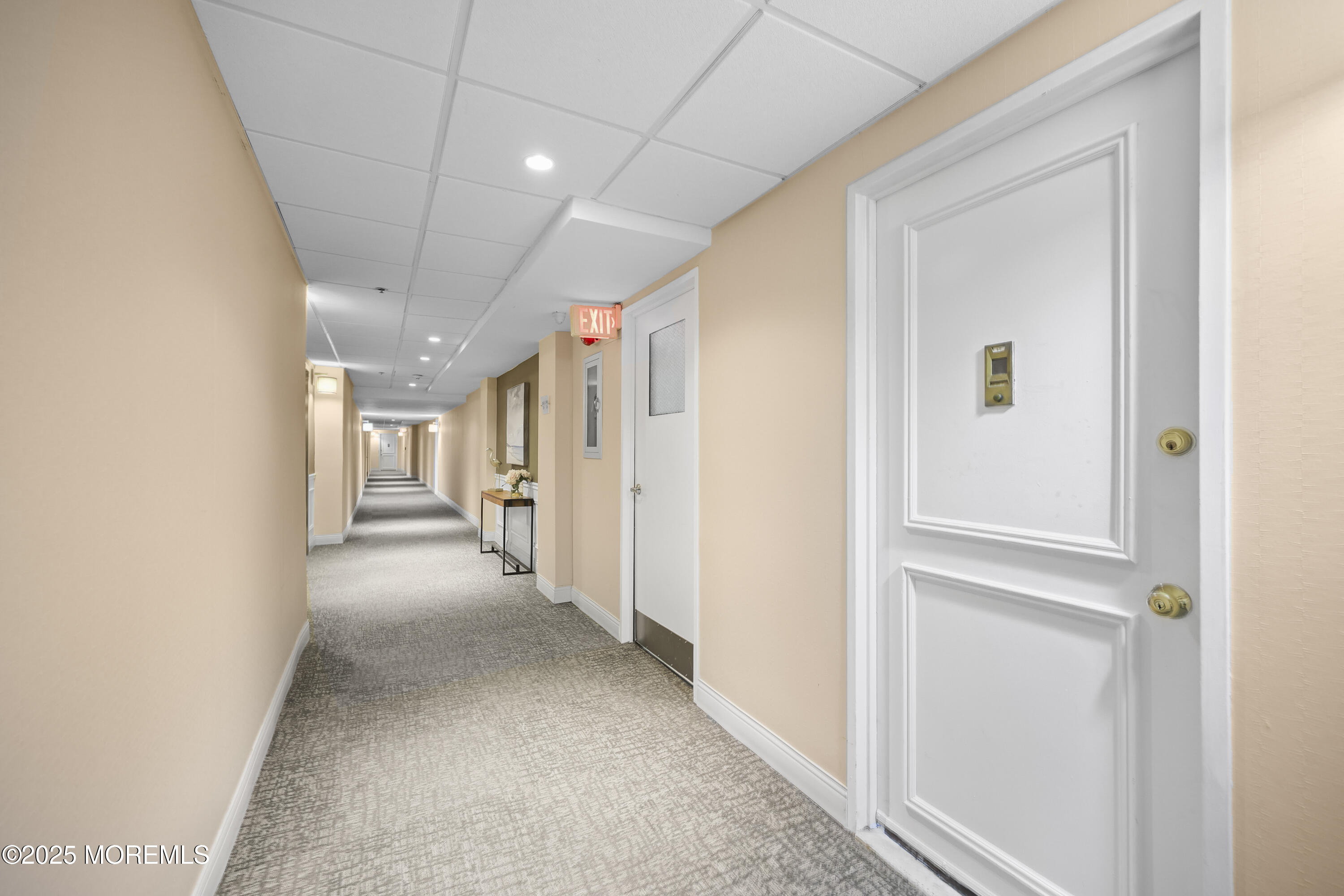 675 Ocean Avenue, Unit 9F Long Branch, NJ 07740 - Photo 2 of 31 a view of a hallway with wooden shelves