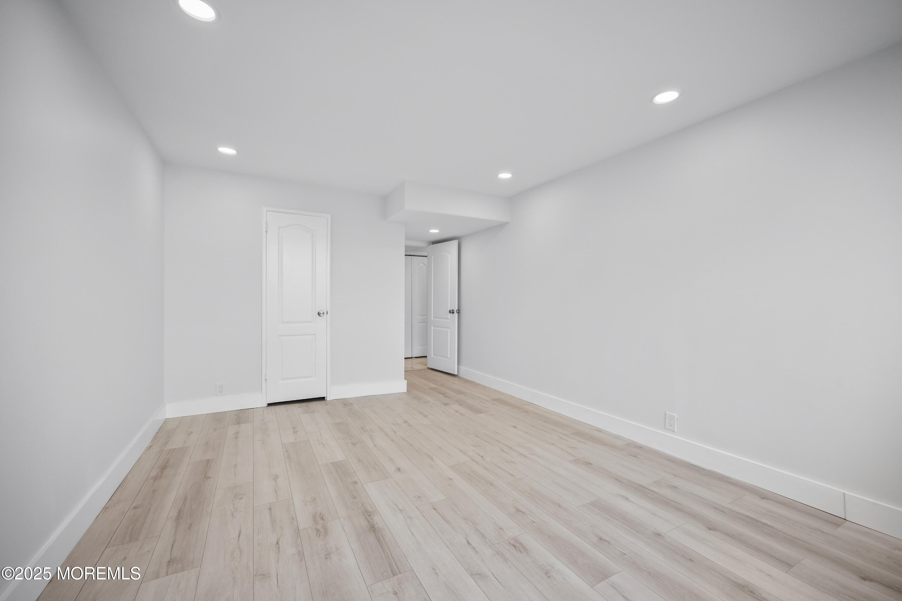 675 Ocean Avenue, Unit 9F Long Branch, NJ 07740 - Photo 2 of 31 a view of an empty room with wooden floor