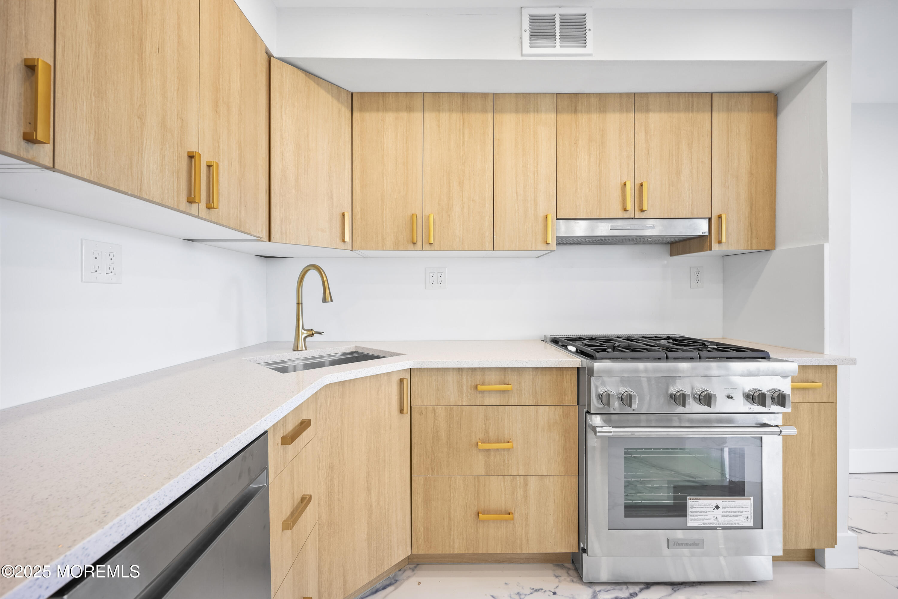 675 Ocean Avenue, Unit 9F Long Branch, NJ 07740 - Photo 26 of 31 a kitchen with granite countertop a sink a stove and cabinets