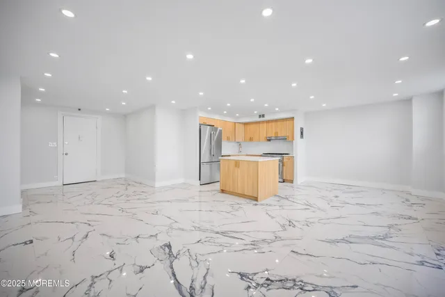 a kitchen with a refrigerator a sink and a microwave