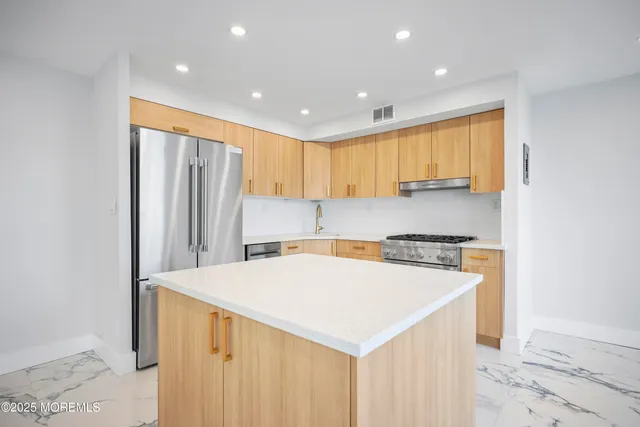 a kitchen with refrigerator and window