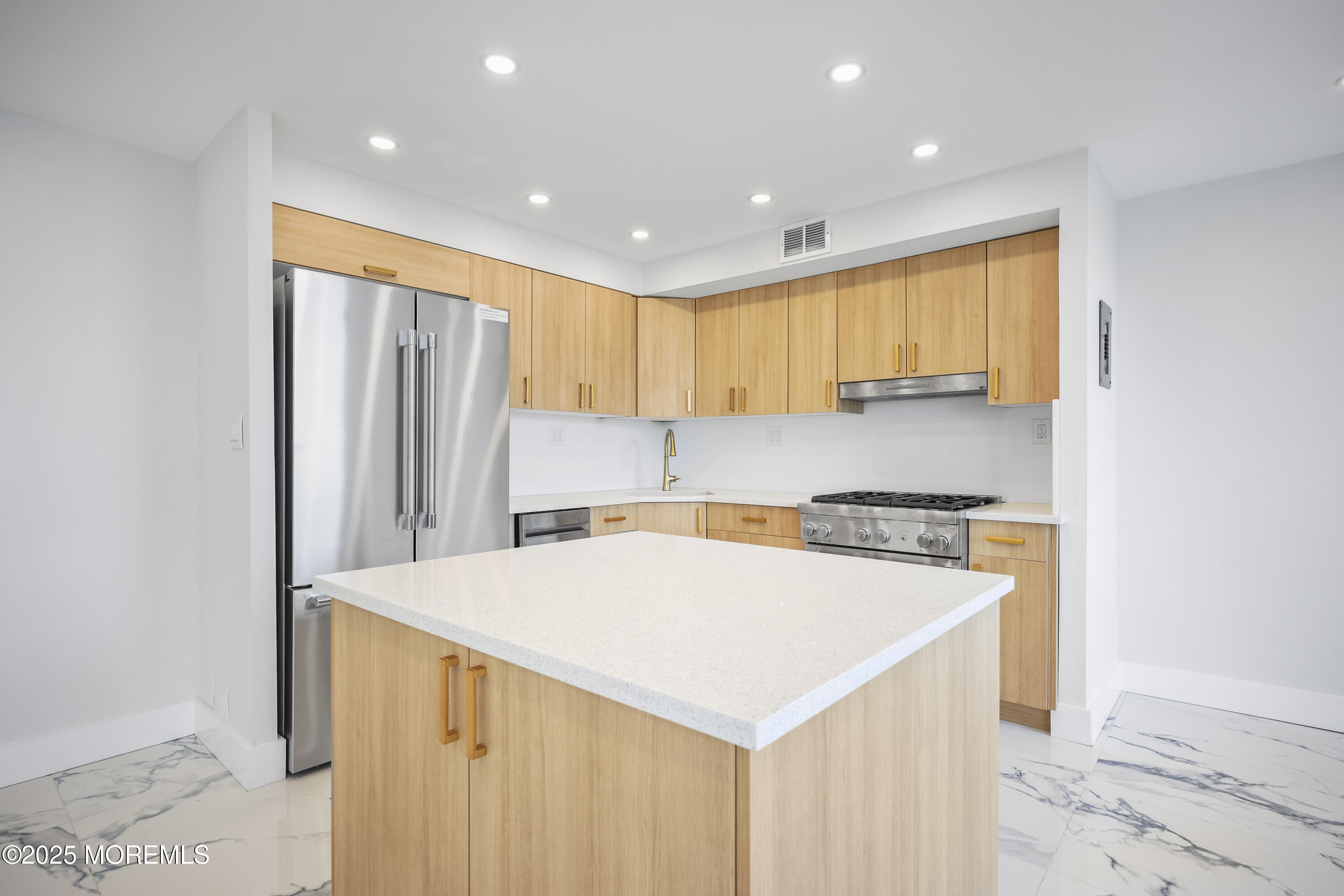 675 Ocean Avenue, Unit 9F Long Branch, NJ 07740 - Photo 7 of 31 a kitchen with a refrigerator a sink and a microwave