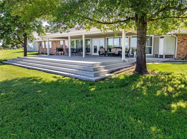 a front view of a house with a yard table and chairs