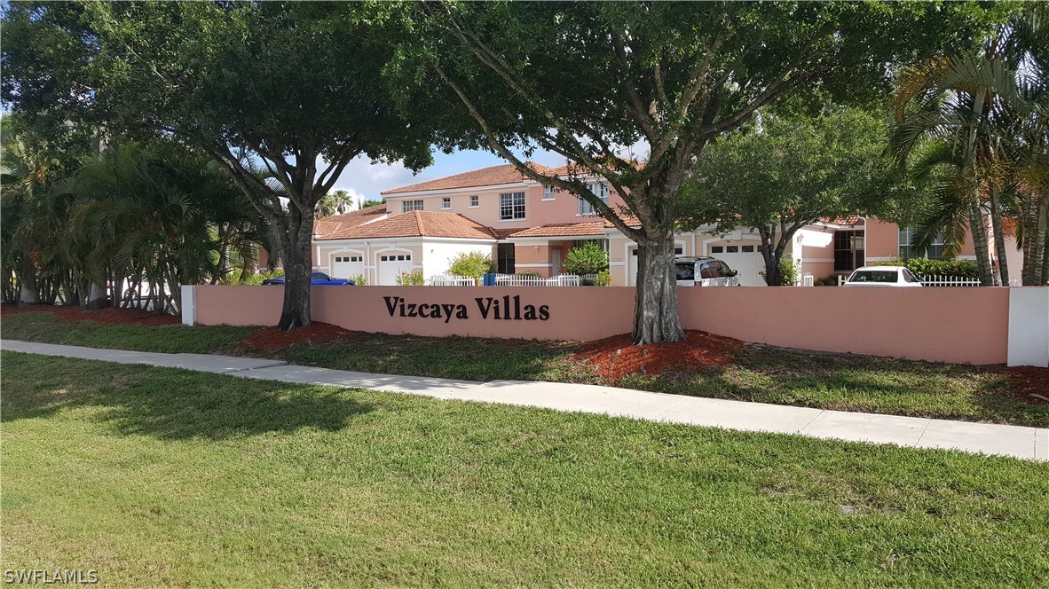 3829 Schoolhouse Road East, Unit 3 Fort Myers, FL 33916 - Photo 1 of 18 a front view of a house with a yard
