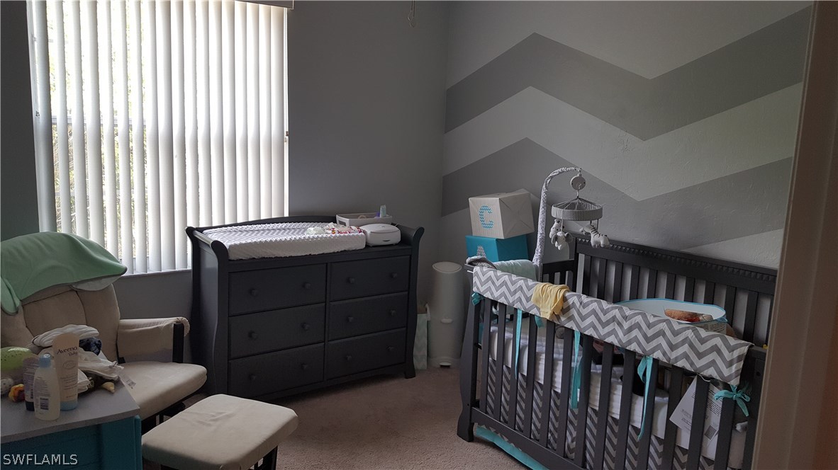 3829 Schoolhouse Road East, Unit 3 Fort Myers, FL 33916 - Photo 11 of 18 a bedroom with a bed and a window