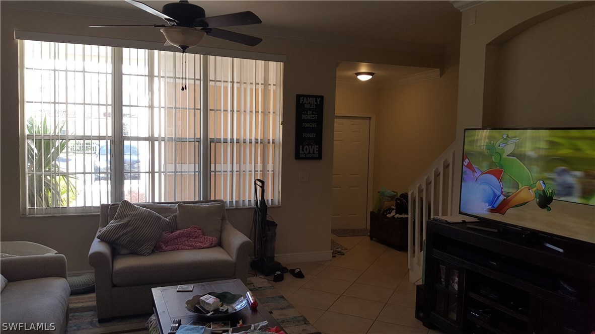 3829 Schoolhouse Road East, Unit 3 Fort Myers, FL 33916 - Photo 3 of 18 a living room with furniture and a flat screen tv
