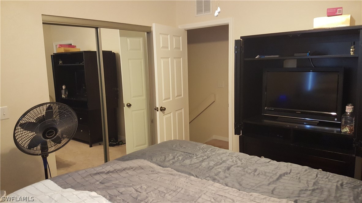 3829 Schoolhouse Road East, Unit 3 Fort Myers, FL 33916 - Photo 8 of 18 a bedroom with a bed and a dresser