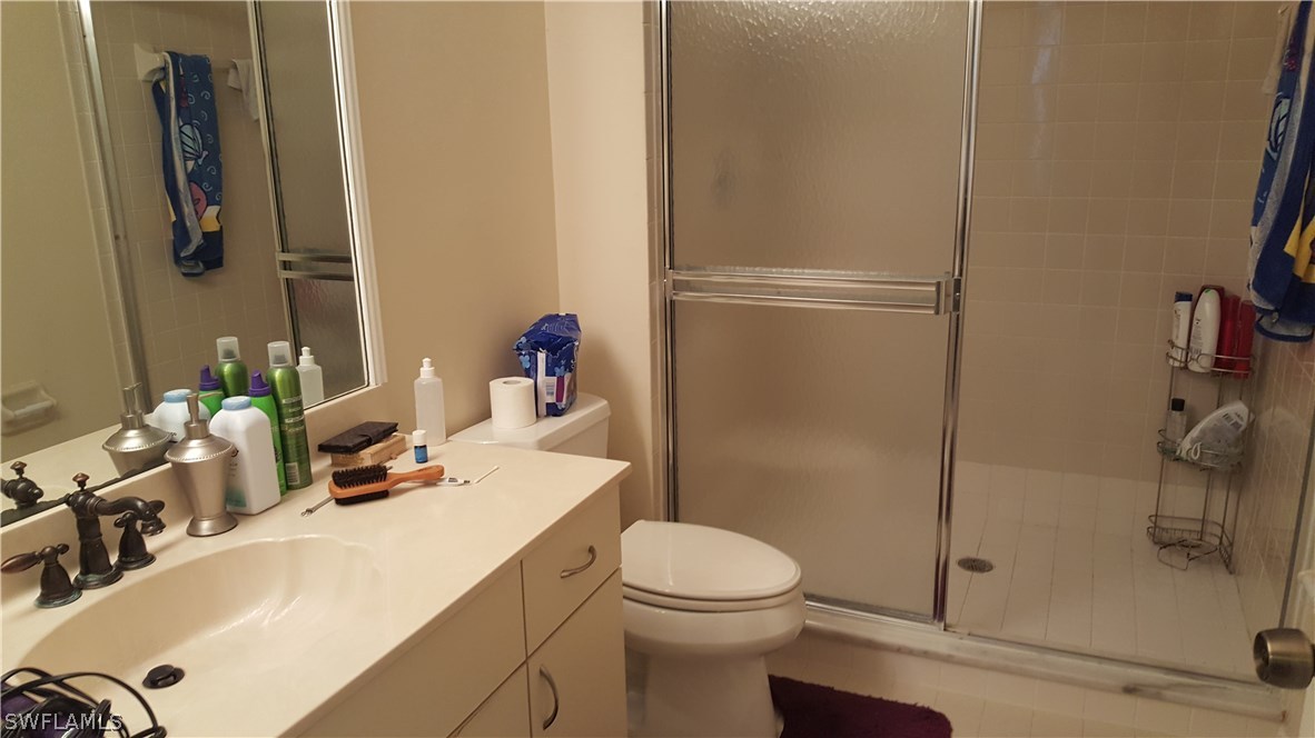 3829 Schoolhouse Road East, Unit 3 Fort Myers, FL 33916 - Photo 9 of 18 a bathroom with a sink toilet and shower