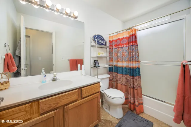 a bathroom with a sink a toilet and shower curtain