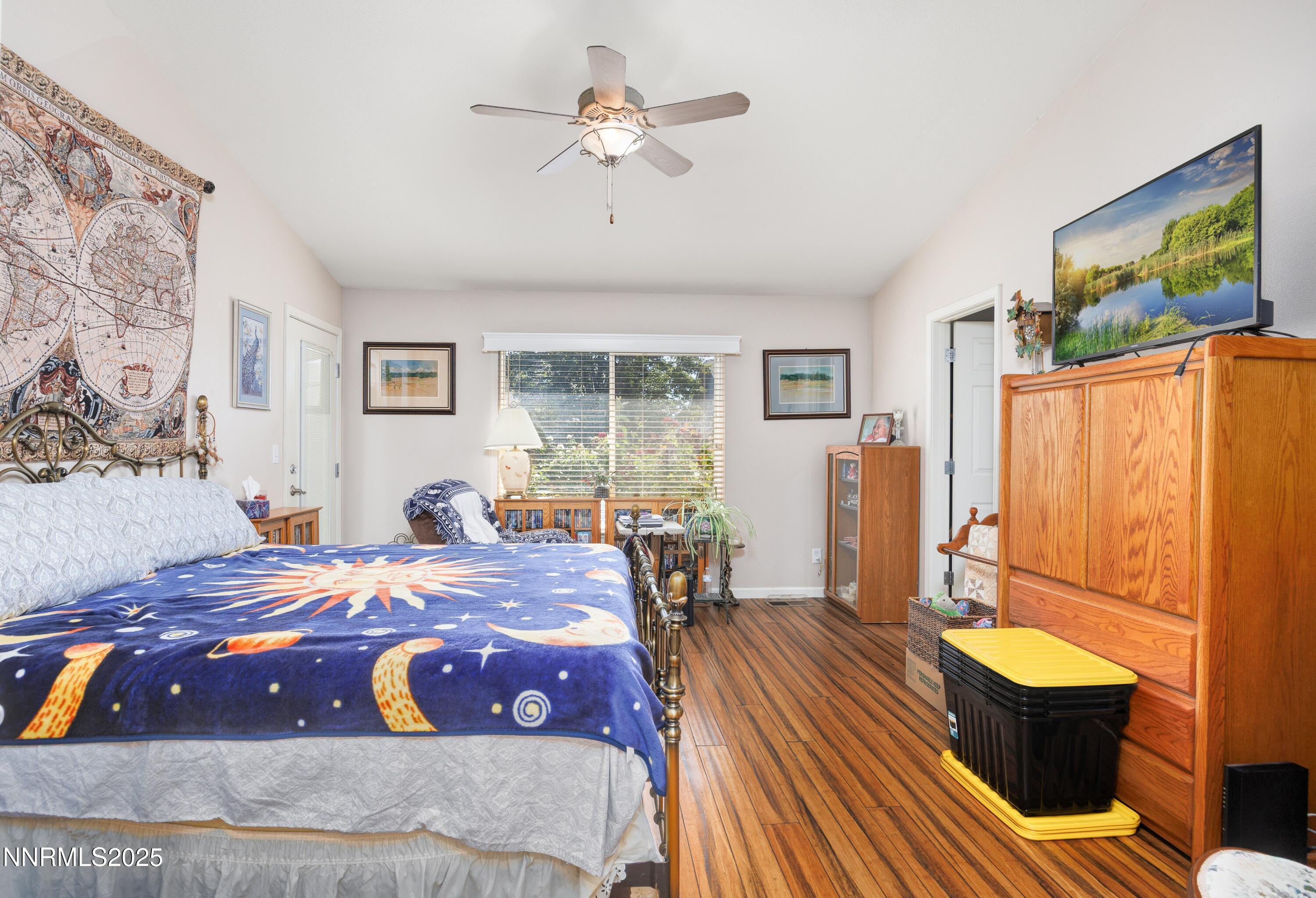 714 Noel Lane Fallon, NV 89406 - Photo 13 of 21 a bedroom with a bed and wooden floor