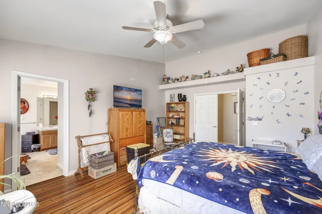 a bedroom with a bed and dresser with mirror