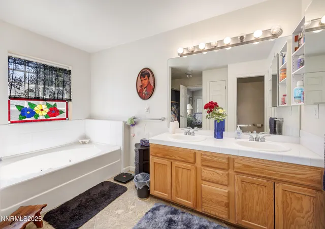 a bathroom with a sink a large mirror and a bathtub