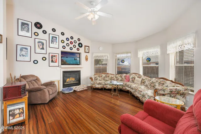 a living room with furniture fireplace and a large window