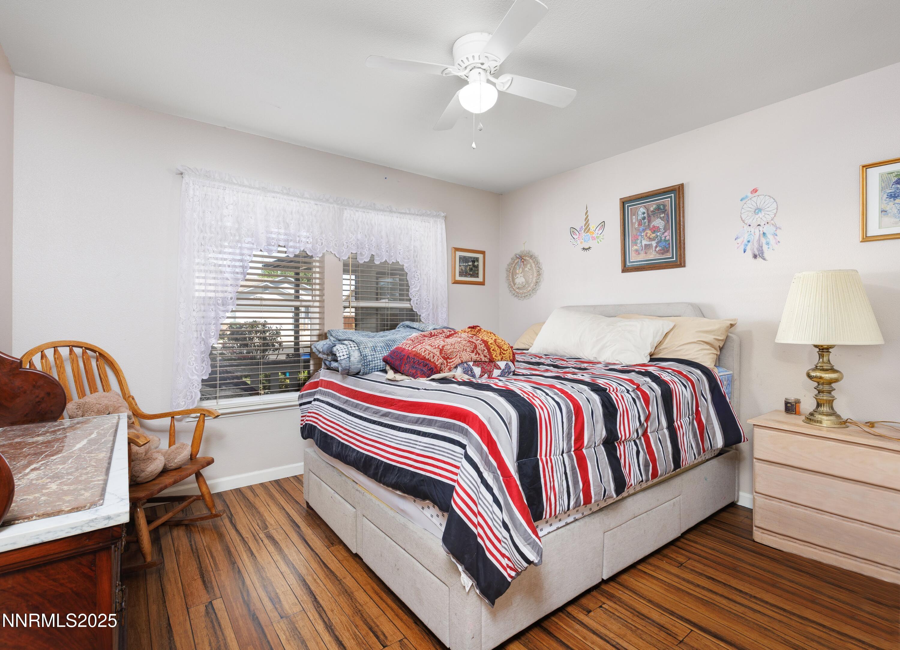 714 Noel Lane Fallon, NV 89406 - Photo 10 of 21 a bedroom with a bed and wooden floor