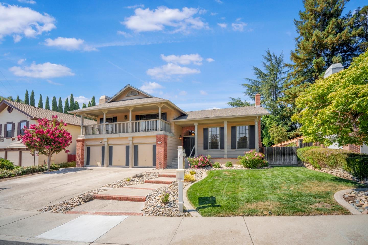 a front view of a house with a garden