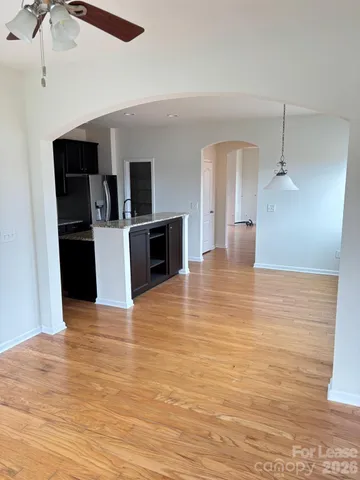 a view of kitchen living space with microwave and stove