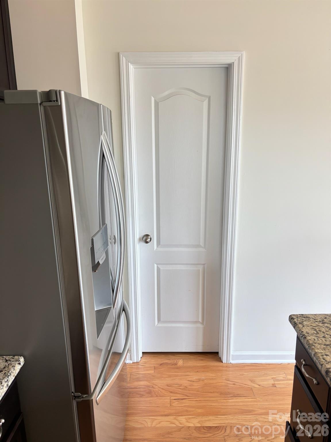 17924 Ragtop Day Lane Cornelius, NC 28031 - Photo 16 of 47 a view of a refrigerator in kitchen and an empty room