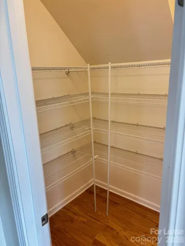 a view of a room with wooden floor and cabinet