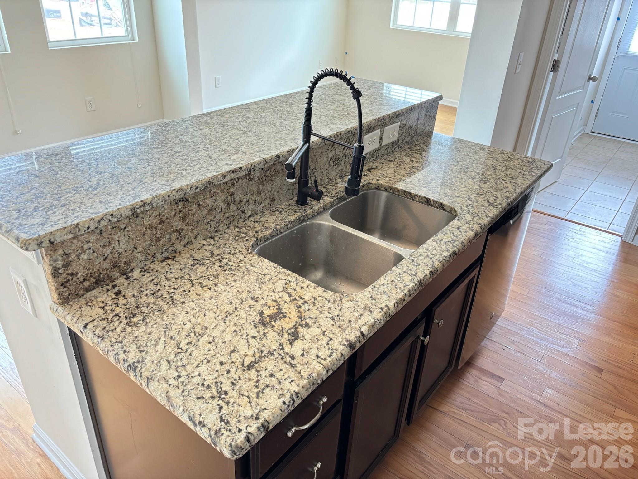 17924 Ragtop Day Lane Cornelius, NC 28031 - Photo 19 of 47 a kitchen with a sink and a wooden floor
