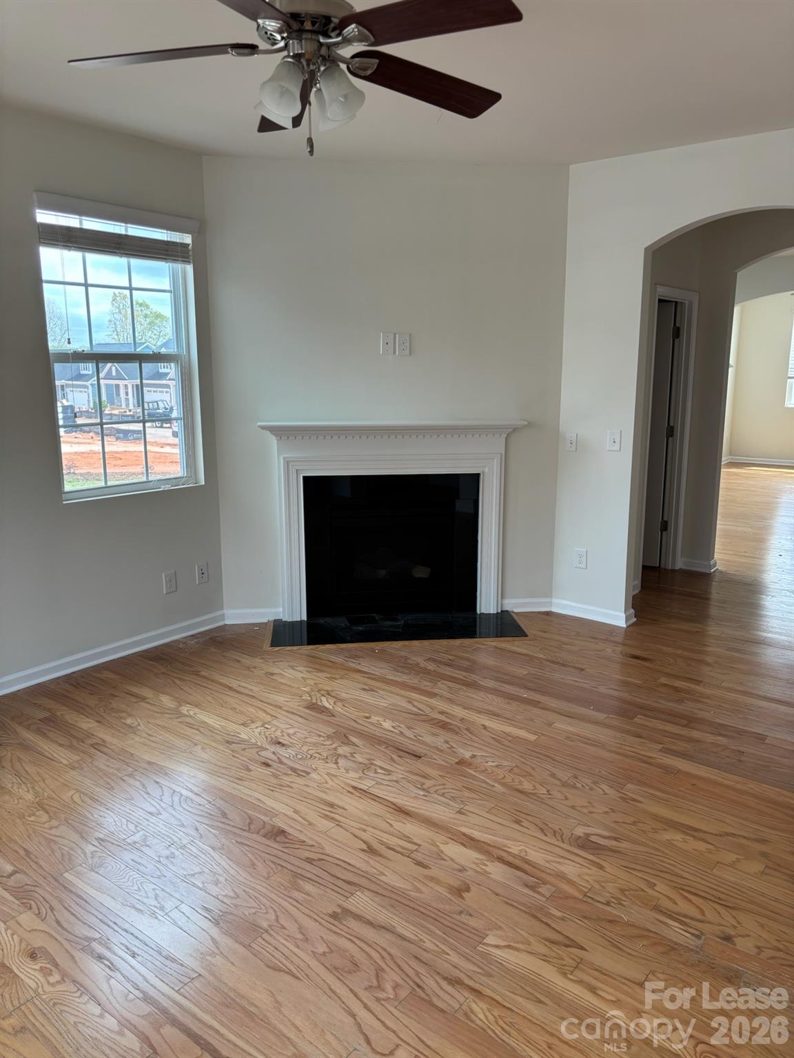17924 Ragtop Day Lane Cornelius, NC 28031 - Photo 3 of 47 a view of empty room with wooden floor and fireplace