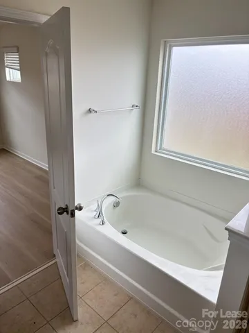 a bathroom with a toilet and a mirror