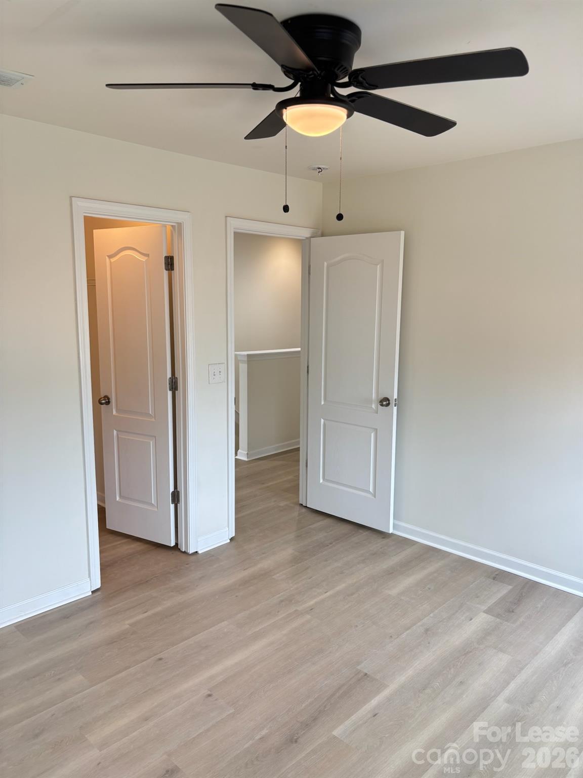 17924 Ragtop Day Lane Cornelius, NC 28031 - Photo 43 of 47 an empty room with wooden floor and fan