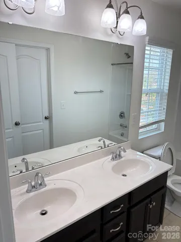 a bathroom with a sink double vanity and a mirror