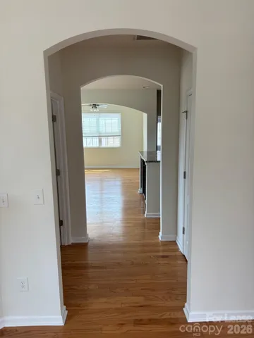 a view of hallway with wooden floor