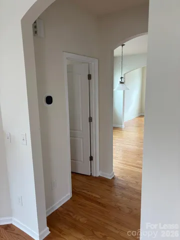a view of a hallway with wooden floor