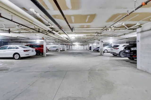a view of parking garage with cars
