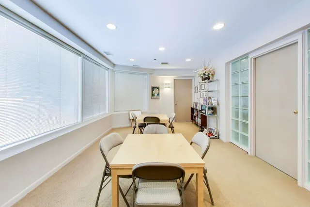 a view of a dining room with furniture and a window