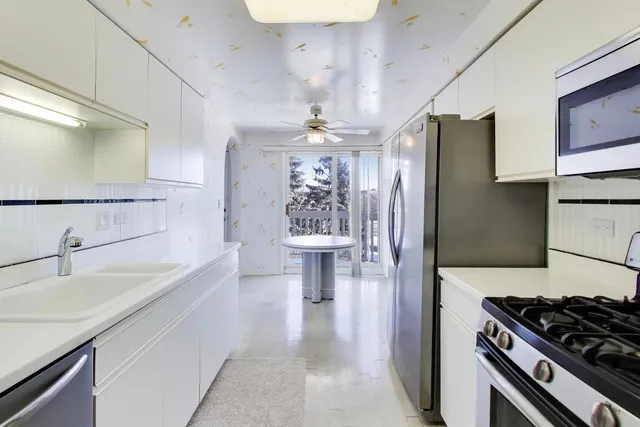 a kitchen with a sink and a refrigerator