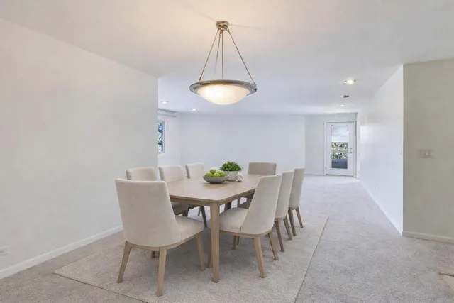 a view of a dining room with furniture and chandelier