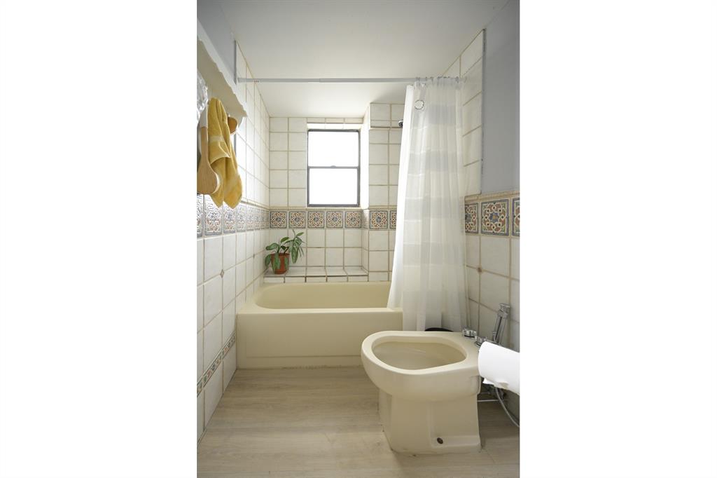 1775 Washington Avenue, Unit 5A Miami Beach, FL 33139 - Photo 12 of 21 a bathroom with a toilet a sink and a bathtub