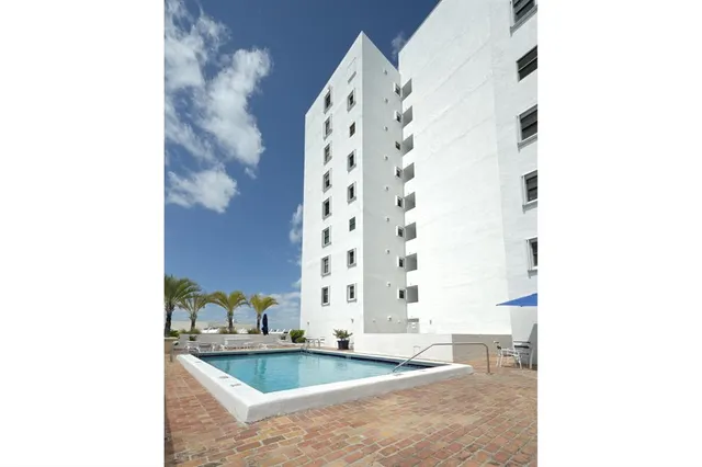 a bathroom with a granite countertop bathtub and sink