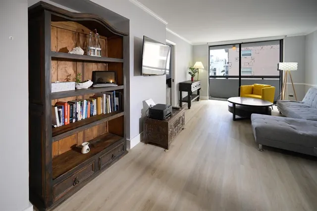 a living room with furniture and a book shelf